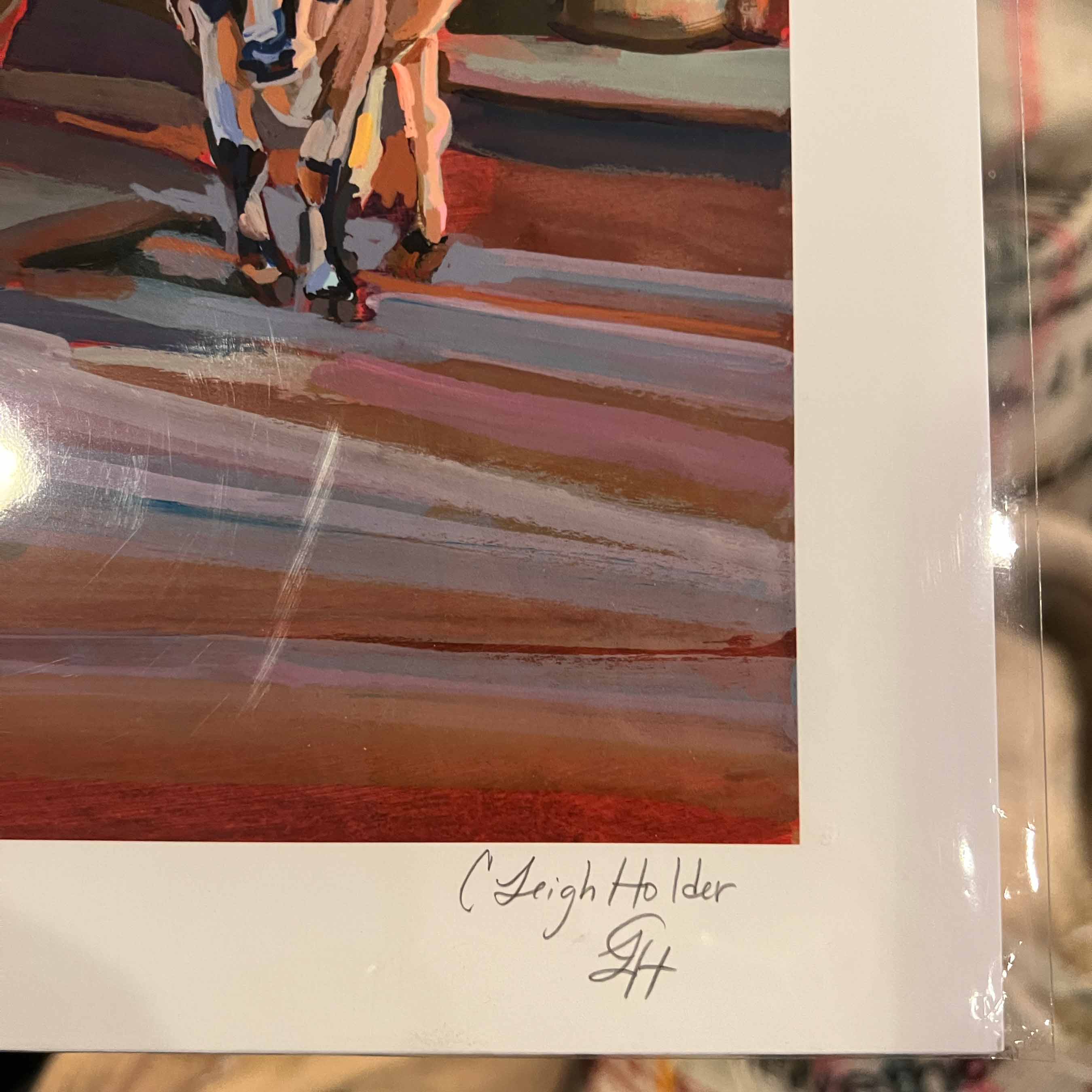 Close up of hand-signed art print of cattle with white border signed 'C. Leigh Holder' at the bottom.